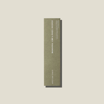 A sage green coloured packet of mandarin, lime and basil incense sticks. 