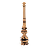 Wooden cacao whisk with decorative design on a white background.
