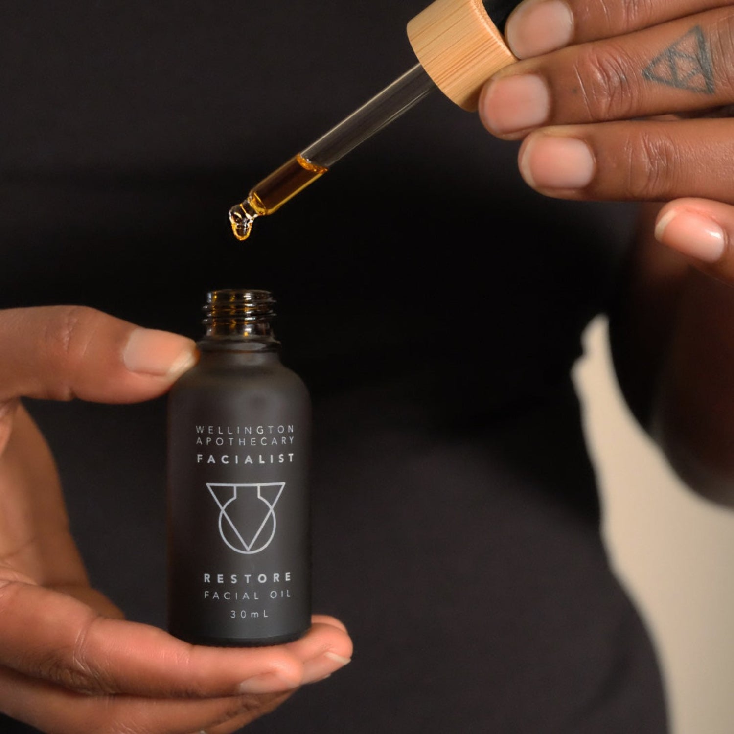 Person holding a bottle of &