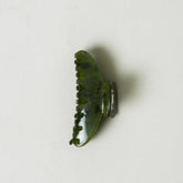 Green hair clip on a white background
