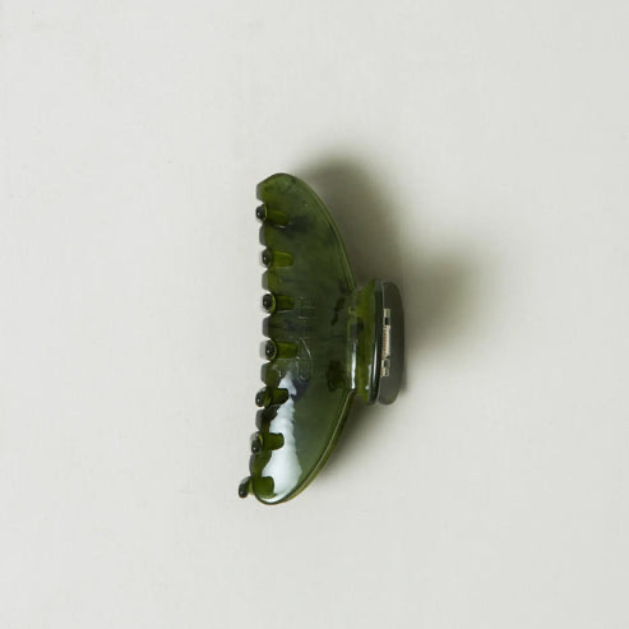 Green hair clip on a white background