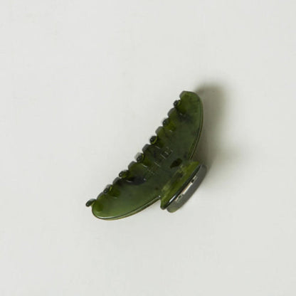 Green claw hair clip on a white background