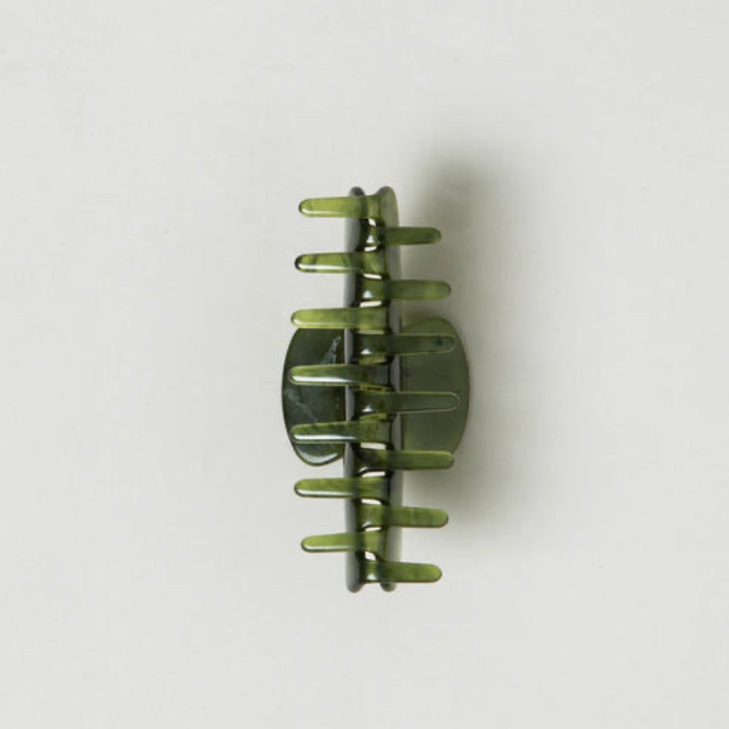 Green hair clip on a white background