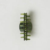 Green hair clip on a white background