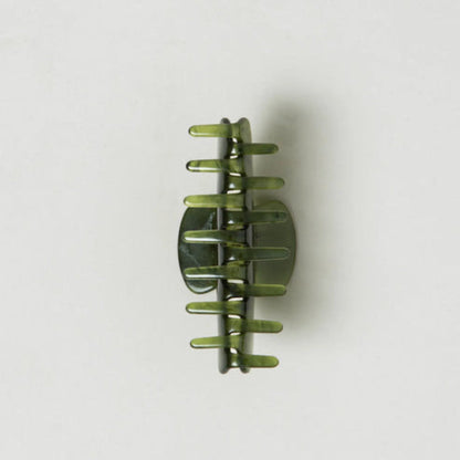 Green hair clip on a white background