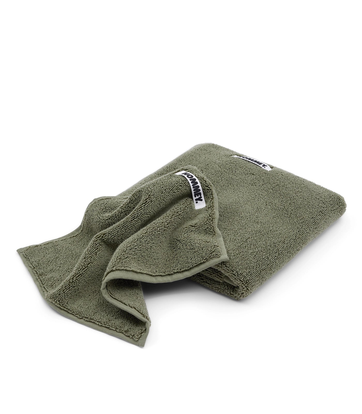 Green towel with a brand label on a white background