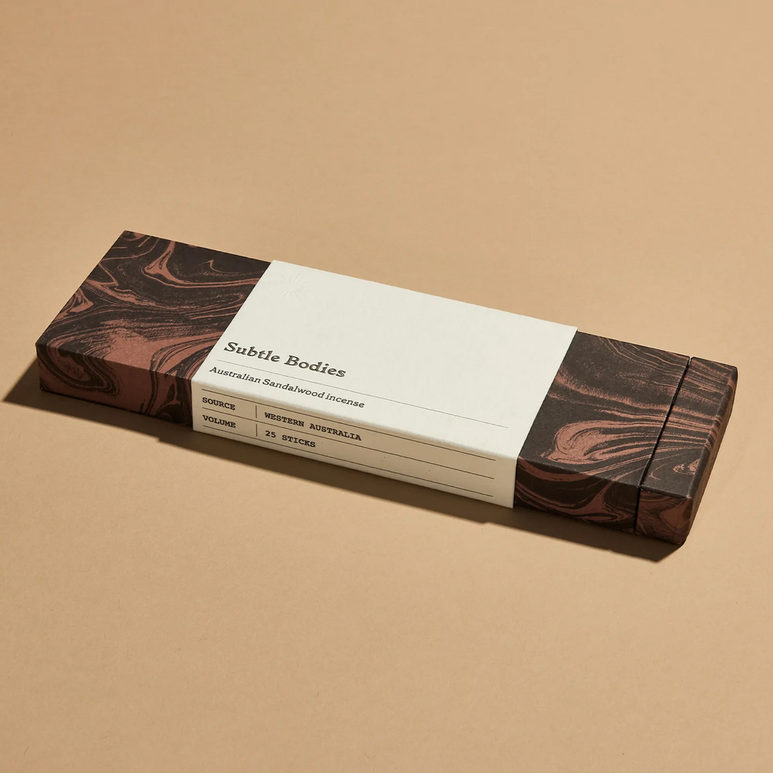 A dark brown box of Australian Sandalwood Incense on beige background.