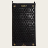 Black acupressure mat with circular patterns on a white background, featuring the brand &