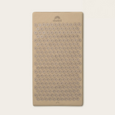 A rectangular beige massage pad with rows of circular textured bumps and the &