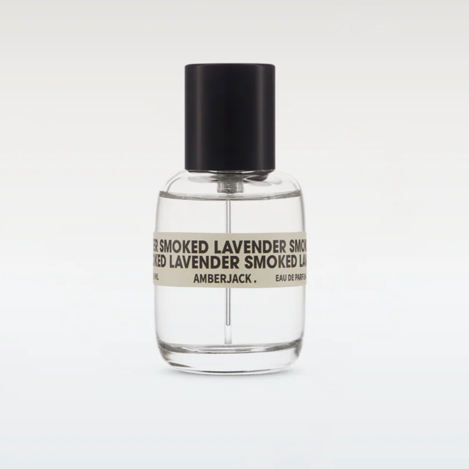 Clear perfume bottle with black cap and label on a white background