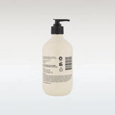 Beige bottle with black pump on a white background
