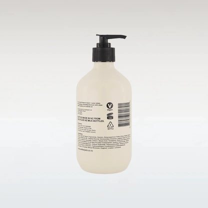 Beige bottle with black pump on a white background