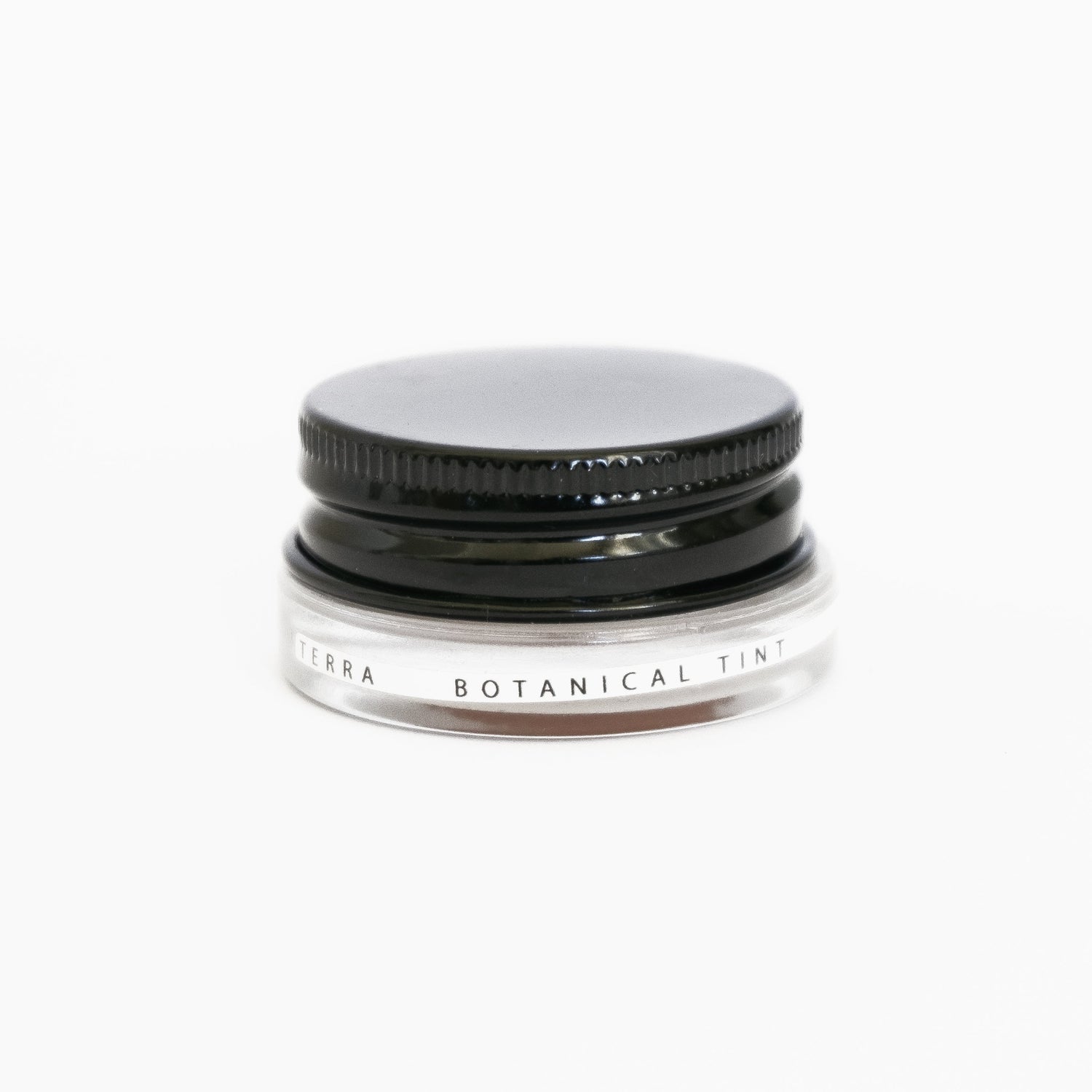 A small glass pottle of Terra lip tint on white background. 