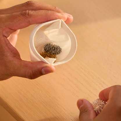 Person holding a small white bag with torus rings