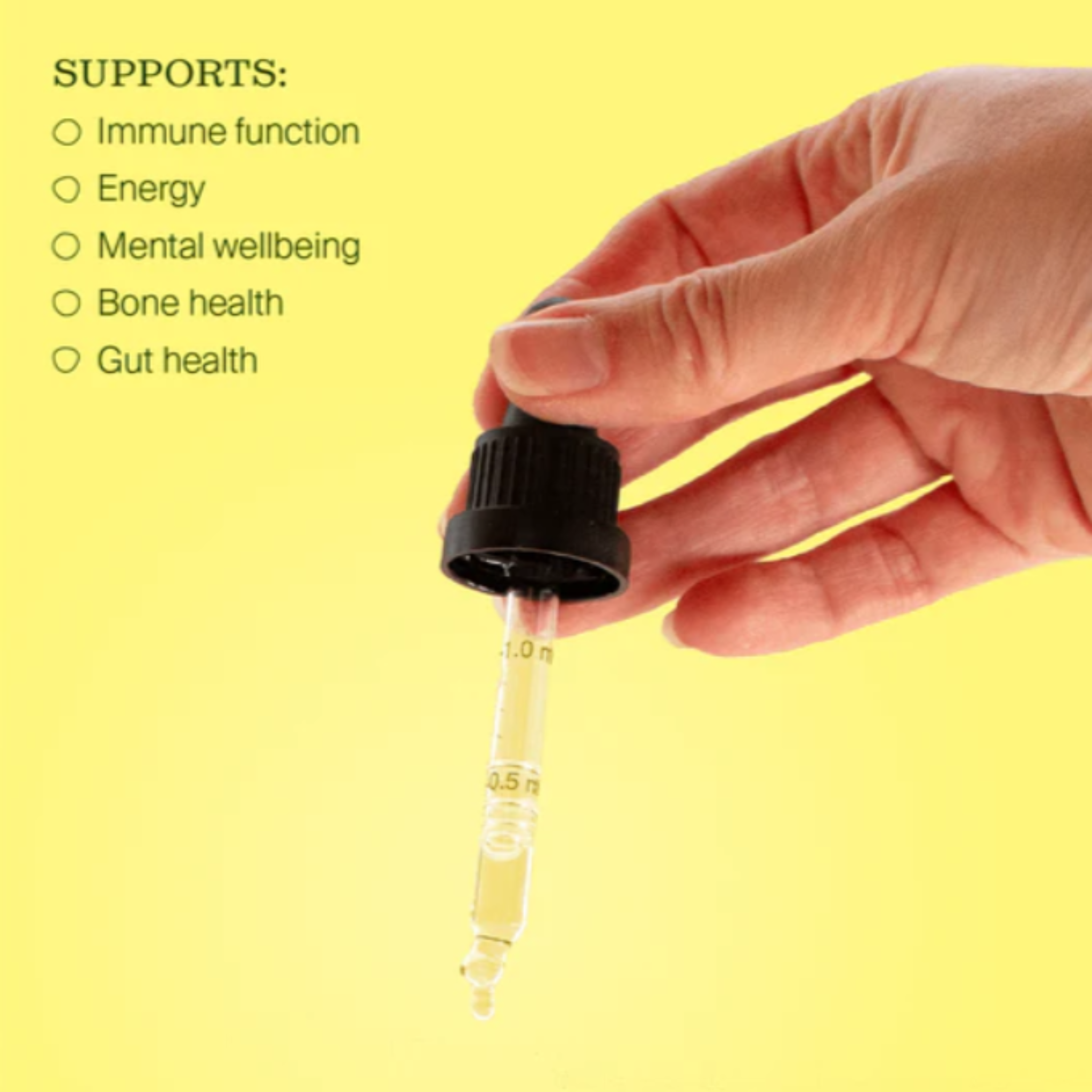 Hand holding a dropper with liquid vitamin d against a yellow background, listing health benefits.