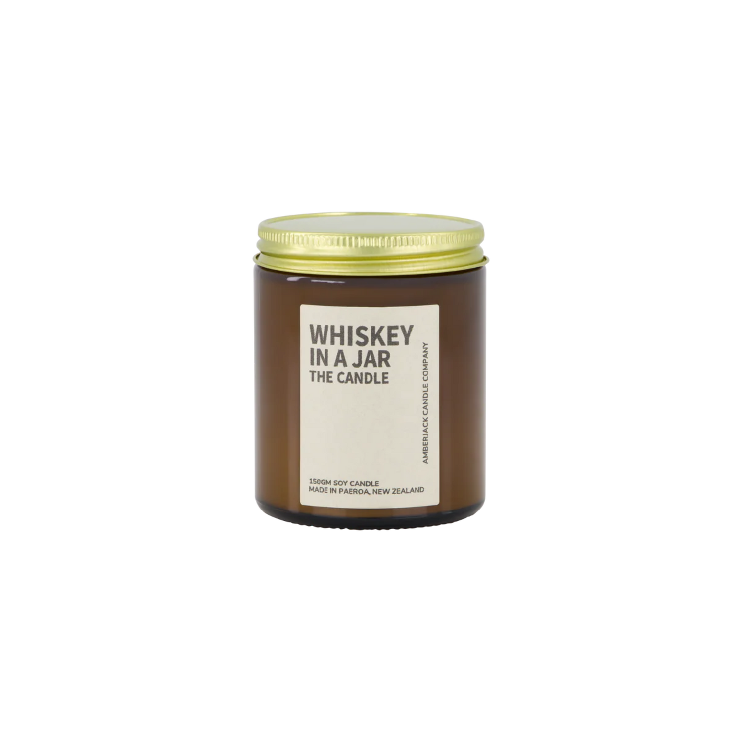 Amber glass jar with brass lid containing whiskey in a jar candle on white background. 
