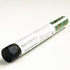 A glass test tube of blue chamomile bath salts on white surface. 