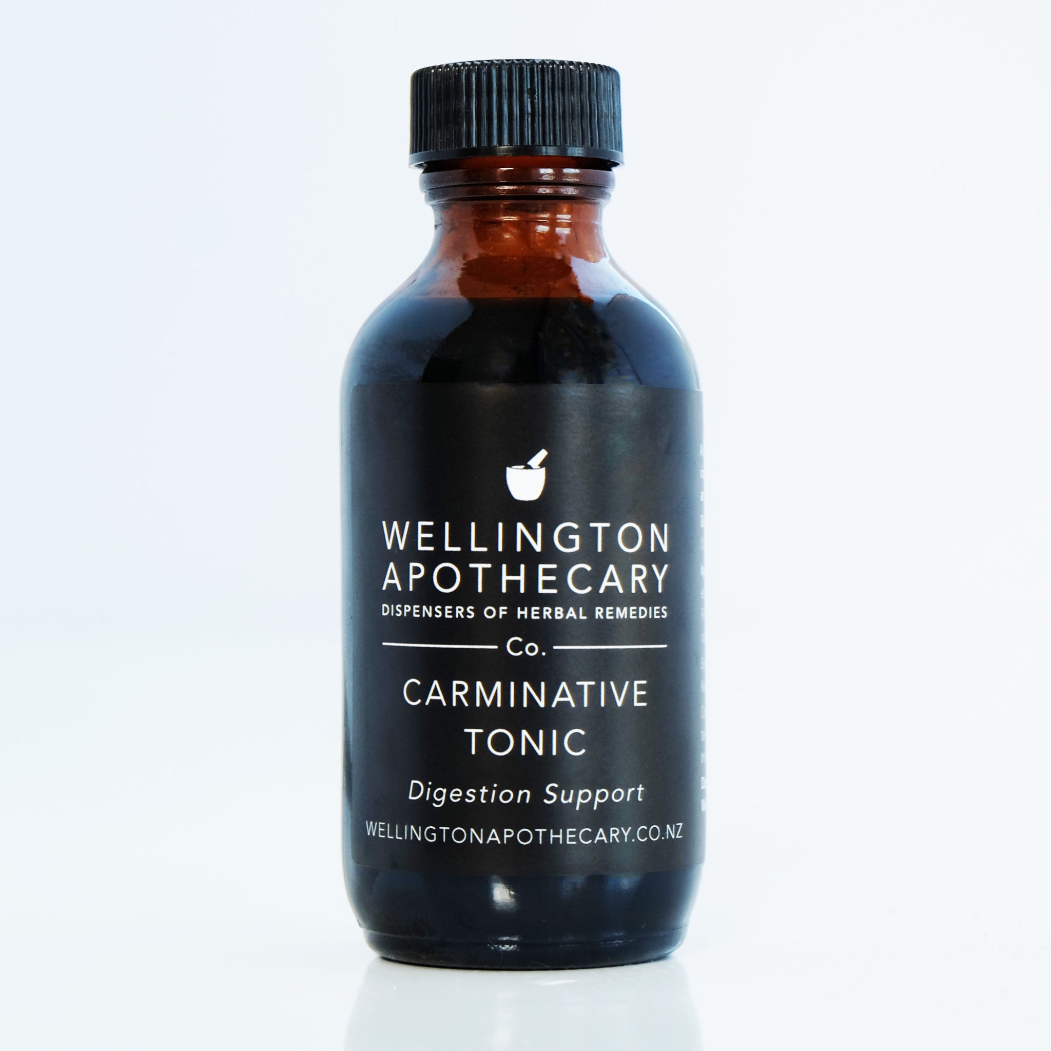 An amber glass bottle of Carminative Tonic for digestion support. 