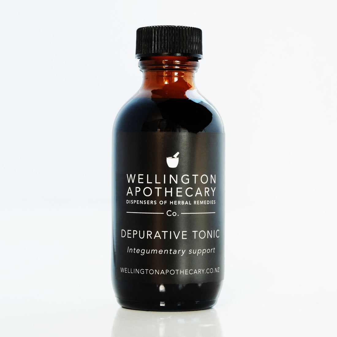 An amber glass bottle of Depurative Tonic for skin support.