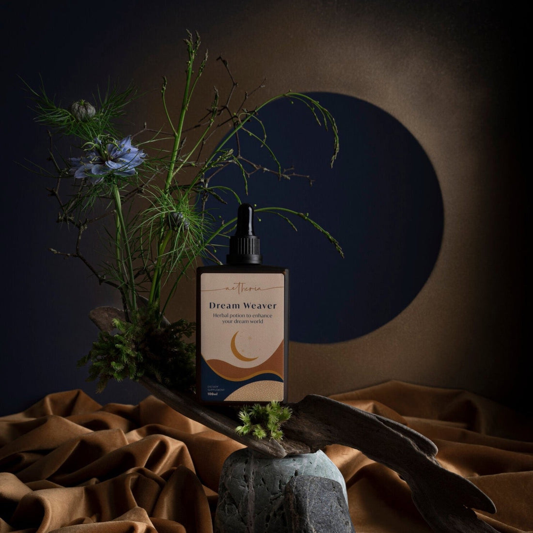 A bottle of Dream Weaver tonic displayed with some of its plant ingredients. 