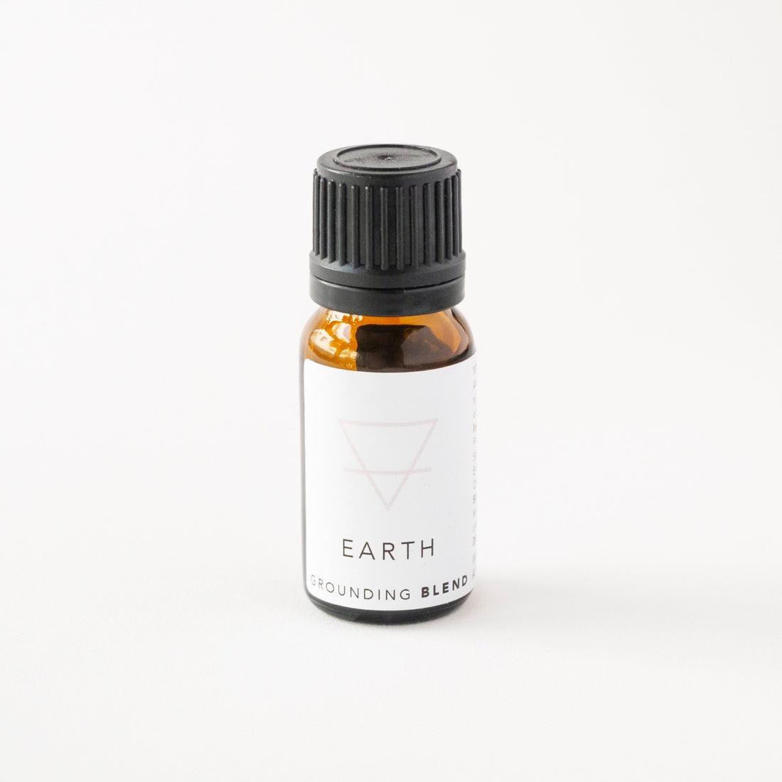 Small amber glass bottle of earth essential oil blend.