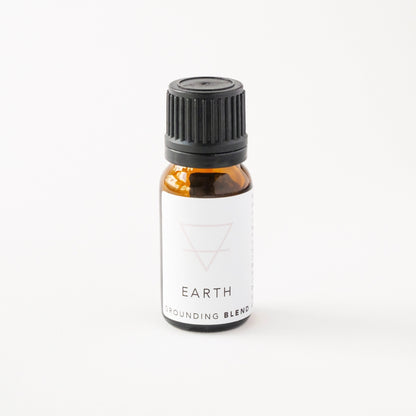 Small amber glass bottle of earth essential oil blend. 