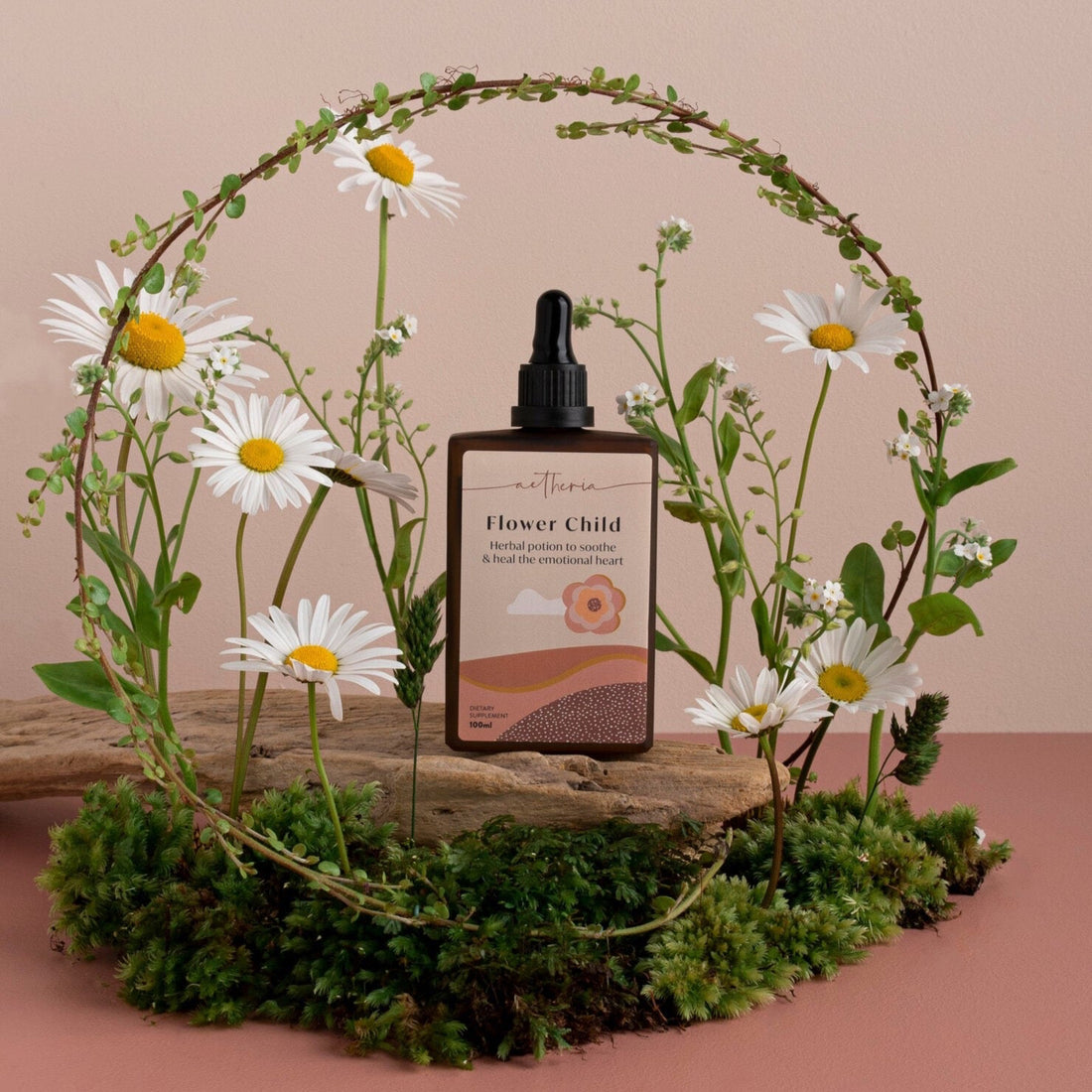 A bottle of Flower Child tonic displayed with some of its plant ingredients. 