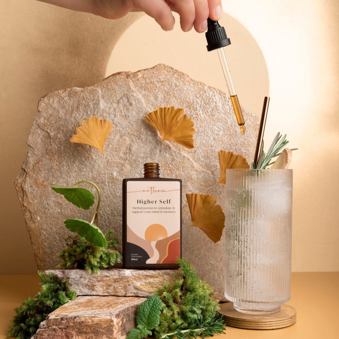 A bottle of Mellow Out tonic being dropped into a tall tonic glass.