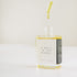 A square glass bottle with a dropper dripping the scent therapy blend - a walk in the woods.