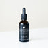 A black bottle of Sleep Sedative tonic on white bench. 