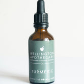 An amber glass dropper bottle of Turmeric herbal tonic. 